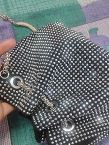 new sling potli bag black and silver in coulour...