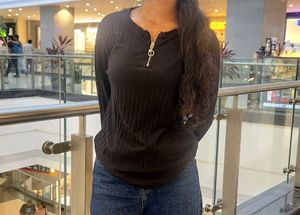 The image features a black ribbed top characterize