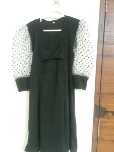 Chic Black Top with Polka Dot Sleeves