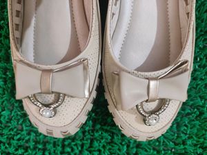 like new cream and golden belly shoe