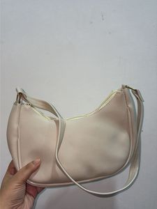Chic Cream Hobo Bag with Gold Bow Accent