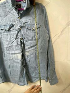 A MILDLY BLUE FADED DENIM SHIRT