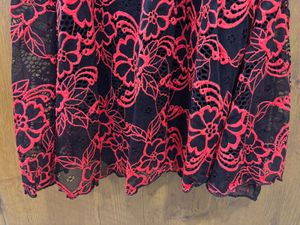 Black lacy dress with red floral detailing