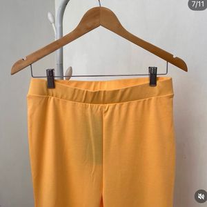 Yellow stretchable flared cotton trousers.
