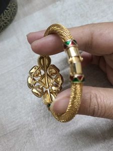 Elegant Gold Bangle with Green Stones