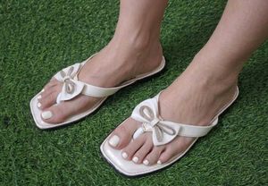 Elegant White Bow Flip-Flops