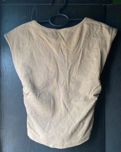 Beige/tan sleeveless top with a V-neck