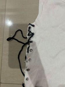 White sleeveless top with lace up detail
