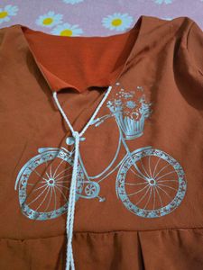 Cute Orange Peplum top with Bicycle Print
