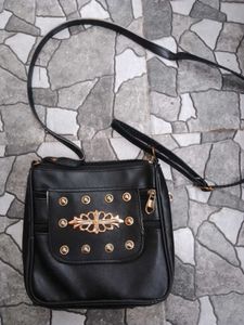 Stylish Black Crossbody Bag with Gold Accents