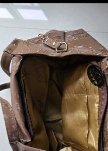 Cute shoulder bag with self color floral print.