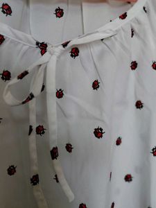 White Top with Red Ladybug Print