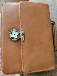 Stylish Tan Handbag with Flower Clasp