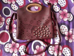 ladies maroon sling bag peacock laser cut