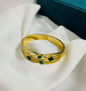 GOLD PLATED BANGLE WITH GREEN STONES