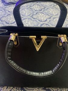 Chic Black Handbag with Gold V Accent