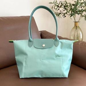 Stylish Teal Hobo Bag with Flower Accent