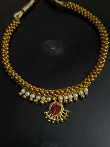 Elegant Gold Tone Necklace with Red Stone