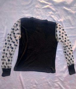 Chic Black Top with Polka Dot Sleeves