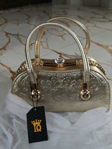 Elegant Gold Clutch with Gemstone Accent