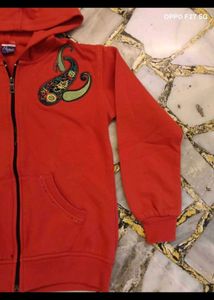 23. Red Zip-Up Hoodie with Paisley Design