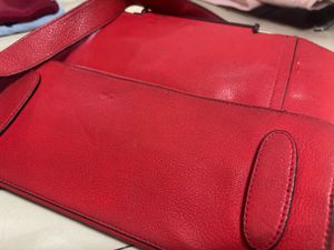 Vibrant Red Handbag with Unique Strap