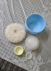 Baby powder puff with a refill container