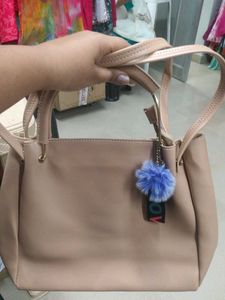Stylish Beige Handbag with Pom-Pom Charm