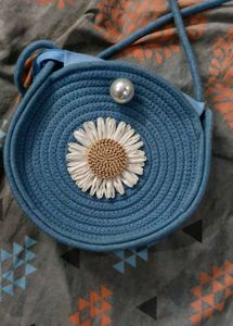 Chic Blue Woven Round Bag with Daisy Accent