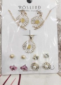 white floral pendant set with 4 pairs of studs