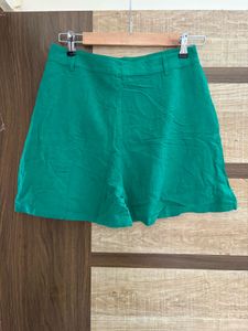 green button fastening shorts