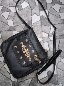 Stylish Black Crossbody Bag with Gold Accents