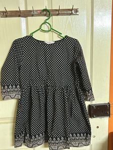 A Black with Beige polka dots top