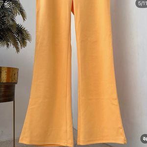 Yellow stretchable flared cotton trousers.