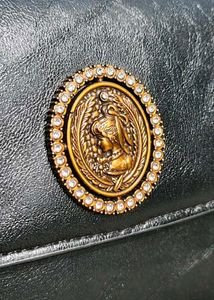 Chic Black Handbag with Gold Emblem