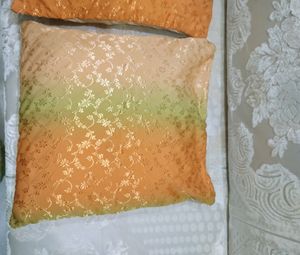 A set of two cushion covers