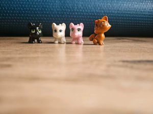 4 adorable cat figurines.