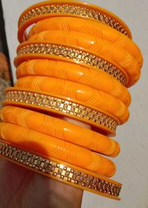 Vibrant Orange Bangle Set with Golden Embellishmen