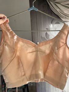 beige sleeveless blouse