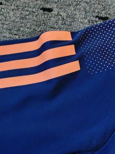 Adidas Blue T-Shirt with Orange Stripes