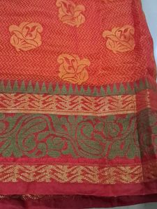 Elegant Orange Saree with Floral Motifs