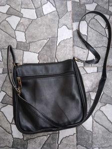 Stylish Black Crossbody Bag with Gold Accents
