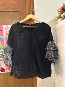 Black top with statement sleeves