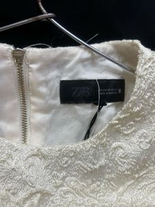 The ivory peplum top
