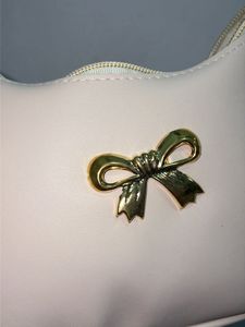 Chic Cream Hobo Bag with Gold Bow Accent