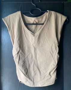 Beige/tan sleeveless top with a V-neck