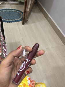 matte liquid lipstick with lip cryon on tip.