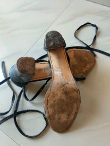 used worn black tie up heels