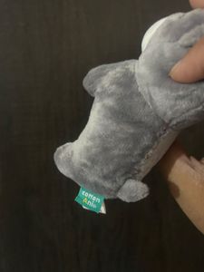 grey and white plush puppy keychain with closed