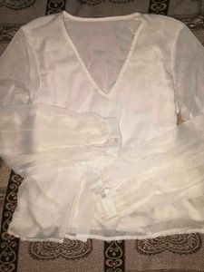 Sheer white peplum top with bell sleeves
